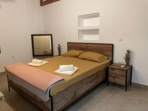 a bedroom with a bed with two towels on it at VILLAMARE in Nerátza