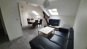 a living room with a couch and a table at Les Gîtes de Jussey in Jussey