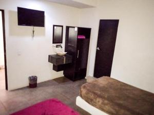 a bathroom with a sink and a toilet and a mirror at Hotel Palacio By Rotamundos in Río Grande