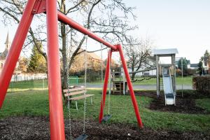 a park with a swing set and a bench at Ferienwohnung Andreas in Tettnang