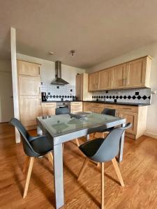 a dining room with a table and chairs in a kitchen at Hotel Residence Bellevue in Cambo-les-Bains