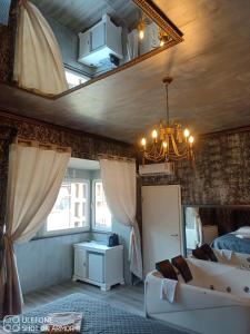 a bedroom with a bed and a chandelier at Valeria's Nest in Reşiţa