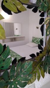 a bedroom with a bed with a mirror and a plant at Marilena in Skala Eresou