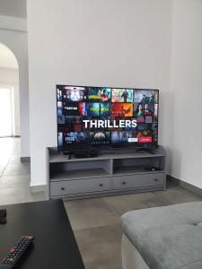 a flat screen tv sitting on top of a entertainment center at Tiszavirág Üdülőház in Kisköre