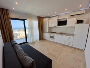 a living room with a couch and a view of the ocean at Apartament Ella front view in Mamaia Sat/Năvodari