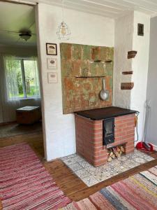 a fireplace in a living room with a brickburning at Aabu Maja in Kõrgessaare +1 photo