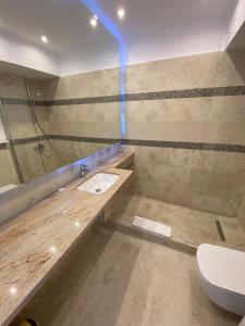 a bathroom with a sink and a toilet at Apartament Ella front view in Mamaia Sat/Năvodari