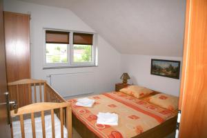 a small bedroom with a bed and a window at Guest House Mijić in Korenica +60 photos