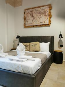 a bedroom with a large bed with white sheets at Loft Porta Sud in Brindisi