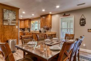 a kitchen and dining room with a table and chairs at River Dance by HoneyBearCabins in Sevierville +36 photos