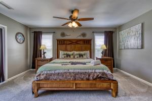 a bedroom with a bed and a ceiling fan at River Dance by HoneyBearCabins in Sevierville
