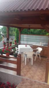 un patio con una mesa blanca y sillas en Pensiunea Irina en Sîngeorz-Băi