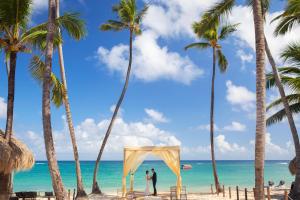 a wedding altar on the beach with palm trees at Royalton Hideaway Punta Cana, An Autograph Collection All-Inclusive Resort & Casino - Adults Only in Punta Cana