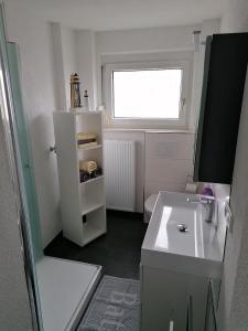a small white kitchen with a sink and a window at Ferienwohnung Ratoldi in Radolfzell am Bodensee