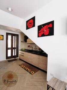 a room with a staircase with red flowers on the walls at IL GIRASOLE in Porto Torres +19 photos