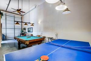 a room with a ping pong table in it at Neptune's Trident in Lincoln Beach