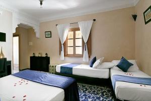 Postel nebo postele na pokoji v ubytování Arabian Riad Marrakech