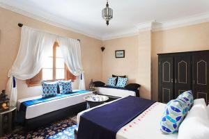 Postel nebo postele na pokoji v ubytování Arabian Riad Marrakech