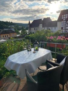 a table with a white table cloth on a balcony at Am Teich in Kamp-Bornhofen