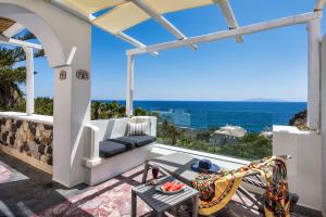 a patio with a view of the ocean at Moschatos Beach House in Kamari