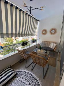 a balcony with a table and chairs and a window at Qerret Boutique Studio Apartment in Golem