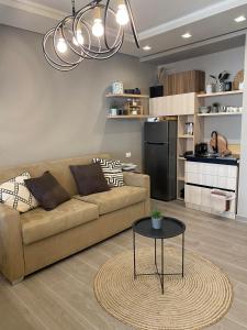 a living room with a couch and a table at Qerret Boutique Studio Apartment in Golem