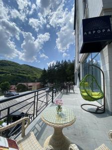 a patio with a table and chairs on a balcony at Aurora Resort by Stellar Hotels, Tsaghkadzor in Tsaghkadzor