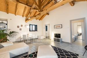 ein Wohnzimmer mit weißen Möbeln und Holzdecken in der Unterkunft Casa Cavagrande in Fornazzo