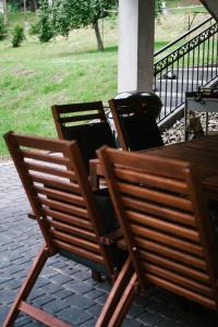 a table and chairs with suitcases sitting on a patio at Komfortowy apartament z bezpośrednim wyjściem na ogród in Kalwaria Zebrzydowska