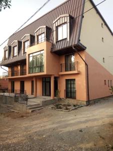 a large building with a gambrel roof at Pensiunea Valea Beiului in Socolari +24 photos