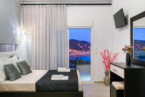 a bedroom with a bed and a large window at Onar in Skala Marion