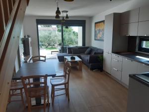 a kitchen and living room with a table and chairs at Altomare in Umag