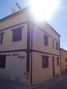 um edifício branco com o sol brilhando sobre ele em Casa Rural Maruja 