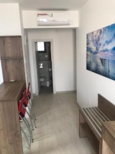 a living room with a bench and a painting on the wall at REZEVICI BOUTIQUE VILLA in Petrovac na Moru