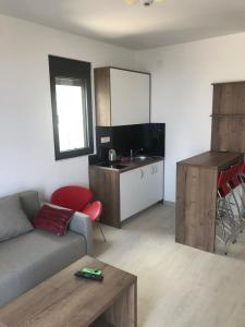 a living room with a couch and a kitchen at REZEVICI BOUTIQUE VILLA in Petrovac na Moru