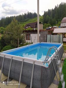 a swimming pool on the roof of a house at Good House in Slavske