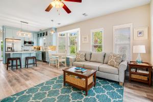 a living room with a couch and a table at Redfish Cottage in Santa Rosa Beach