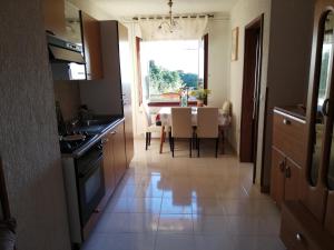 a kitchen and dining room with a table and a window at Apartment Stella in Vodnjan