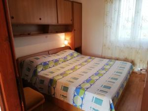 a small bedroom with a bed in a room at Apartment Stella in Vodnjan