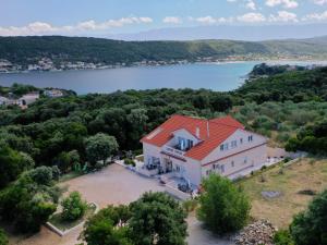 an aerial view of a large white house with a red roof at Apartmani "Sandro" Gonar in Rab