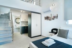 a bedroom with a bed and a staircase at Onar in Skala Marion