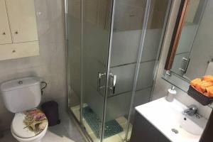 a bathroom with a shower and a toilet and a sink at Apartamento en la playa de Calafell. Barcelona in Calafell +4 photos