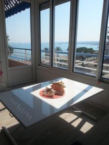 a table in a room with a view of the ocean at La Plage in Cagnes-sur-Mer