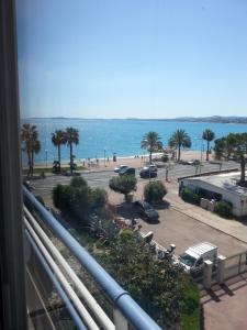 a view of a parking lot and the ocean from a balcony at La Plage in Cagnes-sur-Mer
