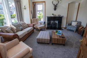 a living room with a couch and a coffee table at Aye Stay Home, city centre in Inverness