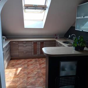 a kitchen with a skylight and a counter top at Agroturystyka Pod Dębem in Jonkowo