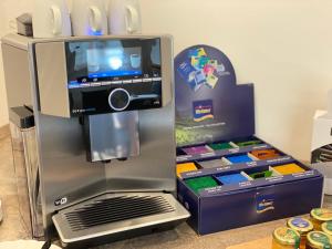 a coffee machine with a box in a room at Pension Holter Deel in Cuxhaven