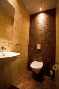 a bathroom with a toilet and a sink at Dirhami Guesthouse in Dirhami