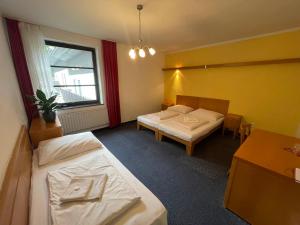 Voodi või voodid majutusasutuse Hotel Bohemia toas