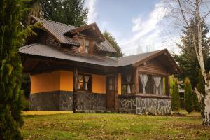 a small house with a gambrel roof at Cabañas Cascada Escondida in El Bolsón